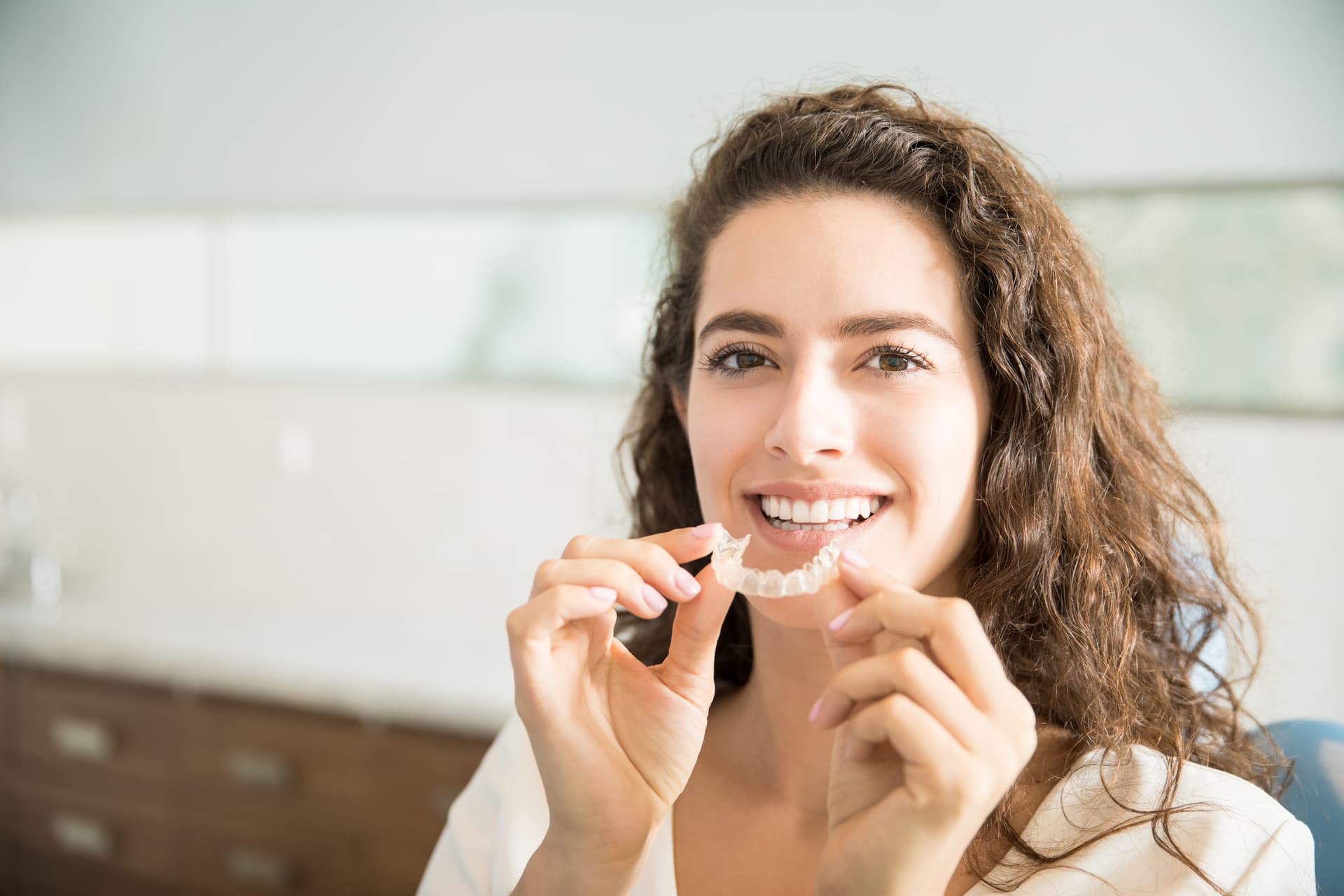 Smiling patient with clear aligners